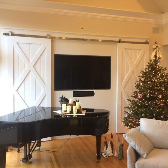 living room with sliding doors and piano - paneled wainscoting